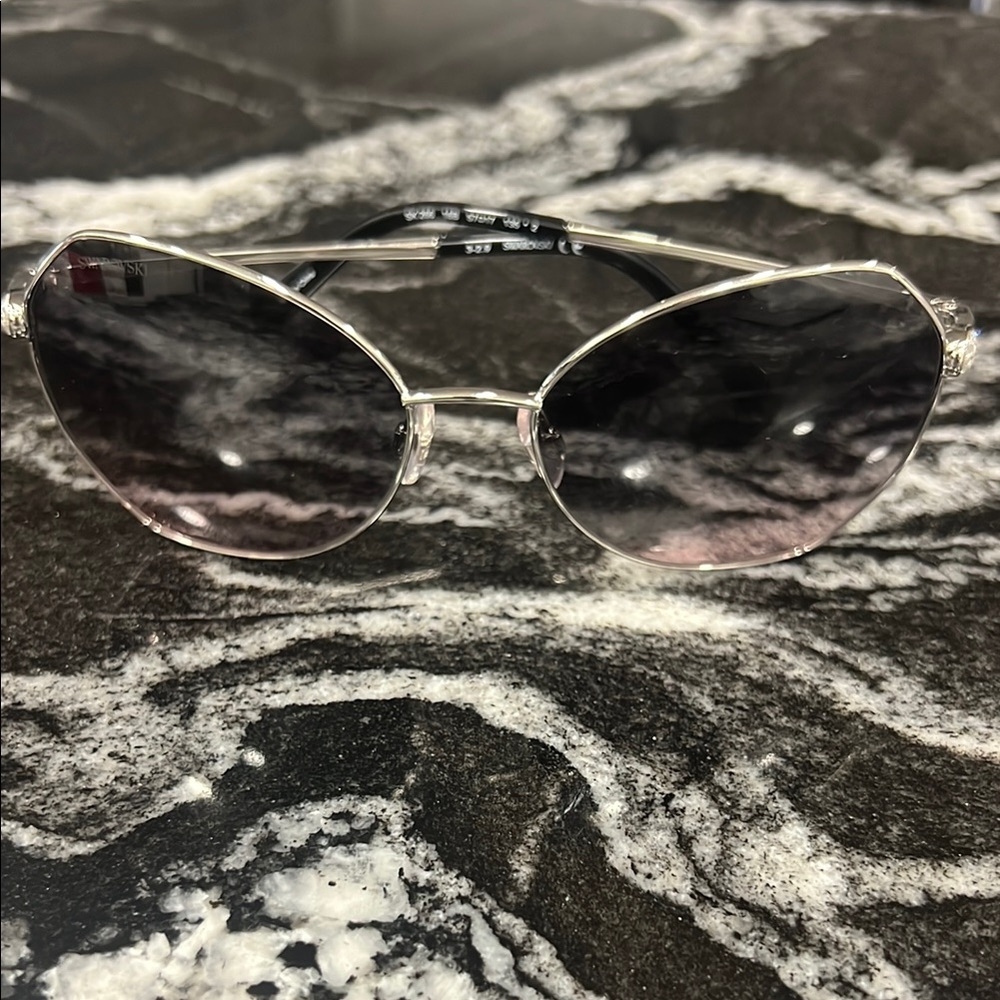 Swarovski Silver Sunglasses with Metallic Frame and Oval Lenses